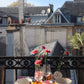 Table colorée sur balcon parisien. Vue sur les toits de Paris. Art de la table par des artisans français, fait à la main.
